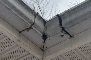 Upclose shot of damaged gutters at intersection