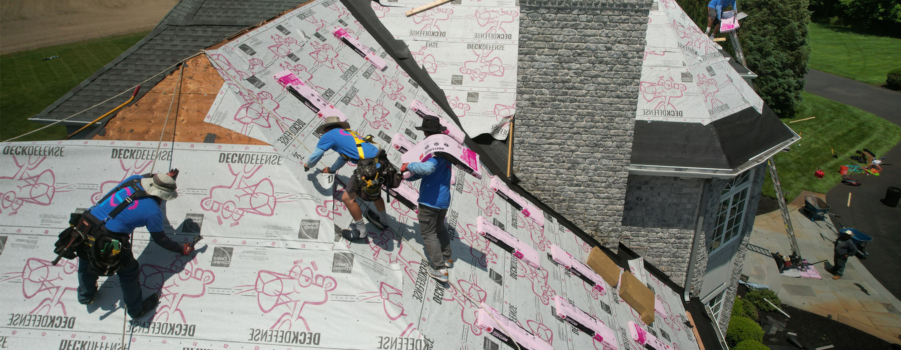 Home Genius remodeling team members replacing a roof