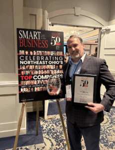 HGE CGO Tim Dunphy holding an award at the Fast 50 2025 ceremony