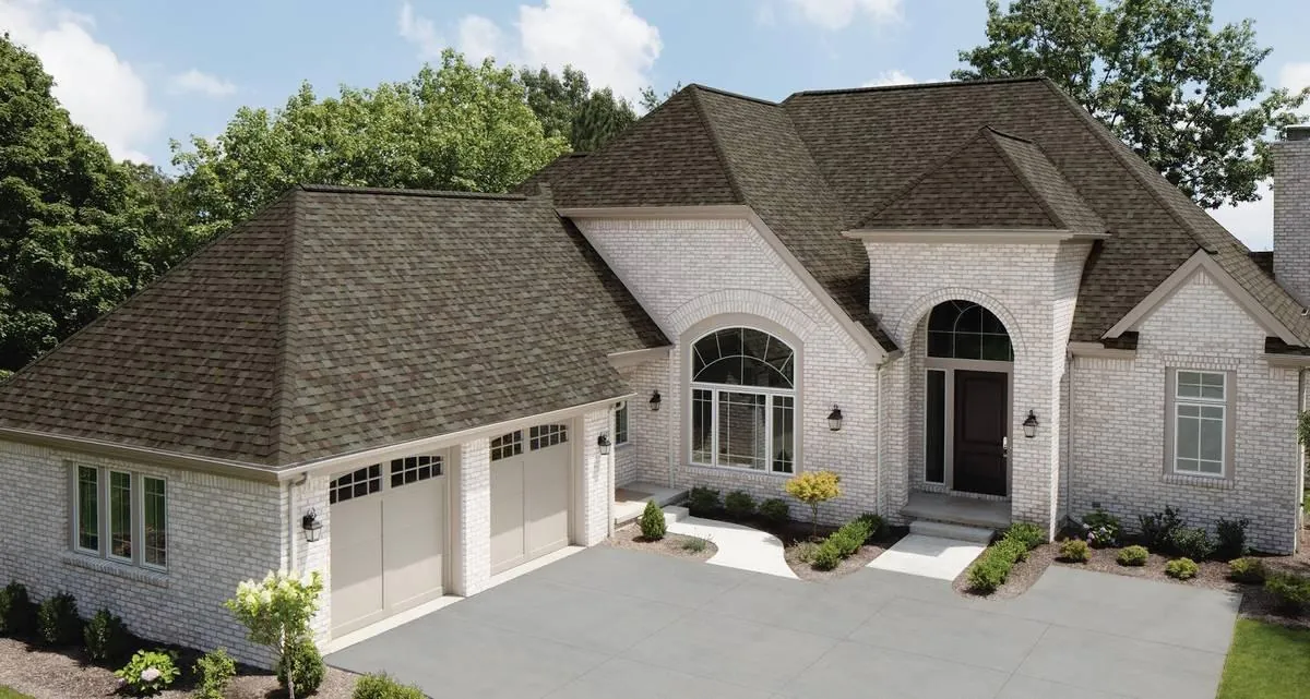 A dark brown architectural asphalt shingle roof gives this brick home a polished, traditional look.