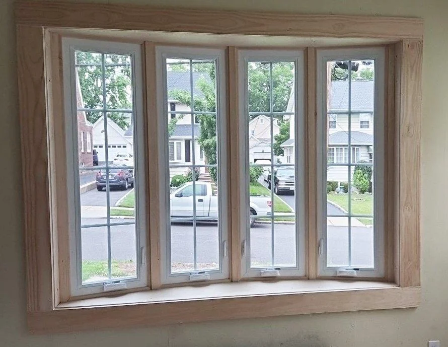 Four casement windows, each with its own crank handle at the sill, sit side by side in a wide opening.