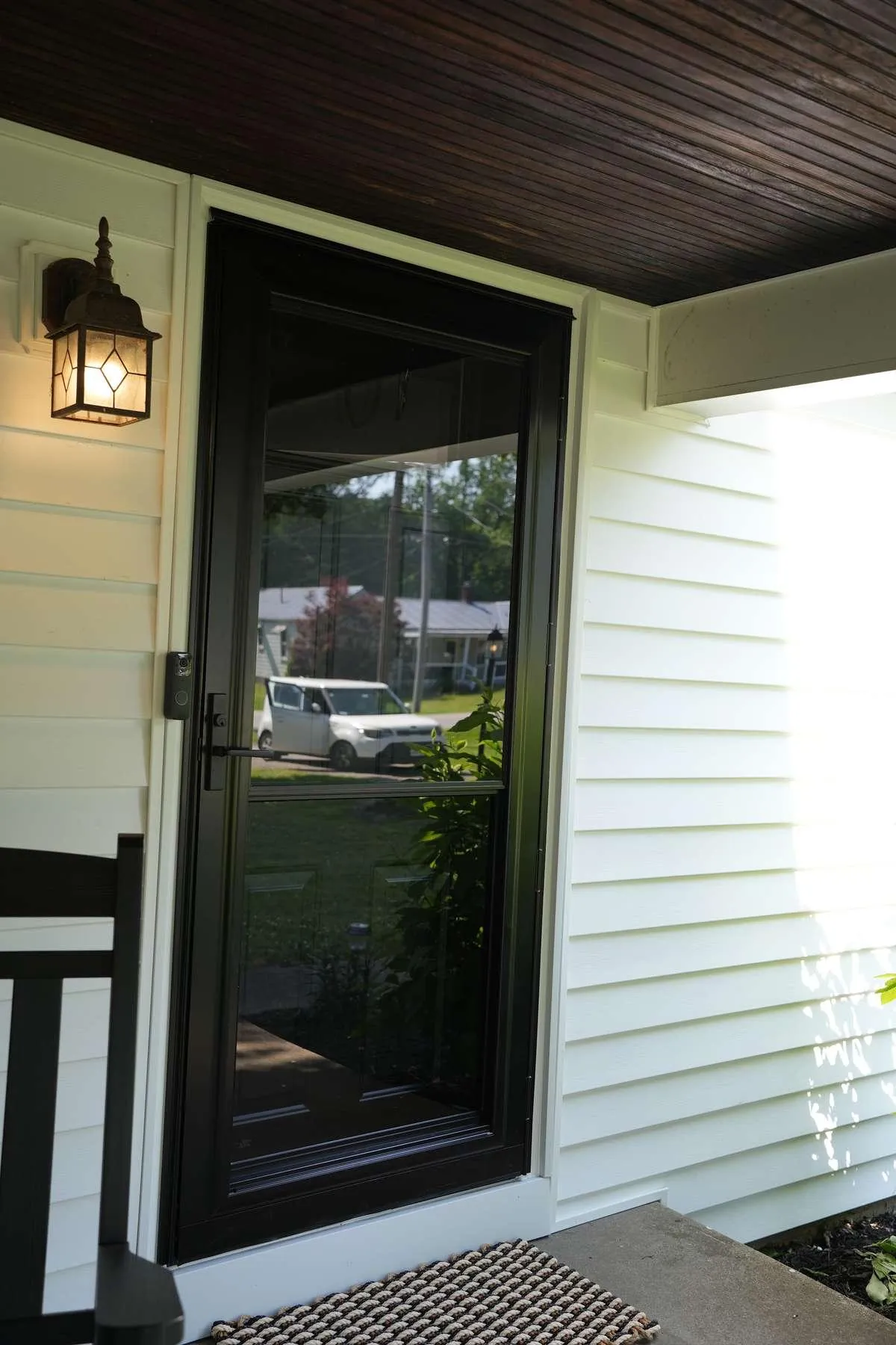 A storm door with glass running nearly top to bottom shows the full-view style this section compares to mid-view.