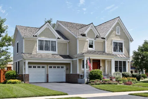 Cream Vinyl And Composite Siding On Suburban Home