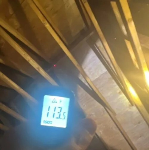 temperature meter showing an attic over 100 degrees