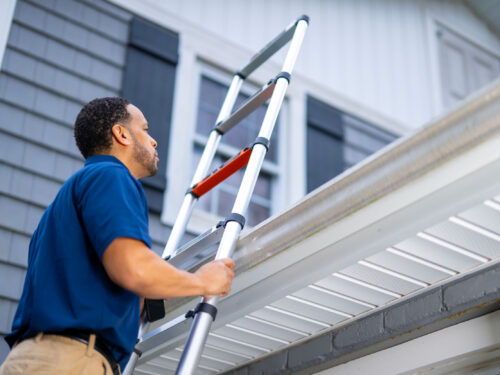 Home Remodeling Expert Inspects Gutter