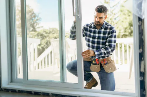 Home Genius Professional installing a customized sliding glass door leading to the home's deck and back yard.