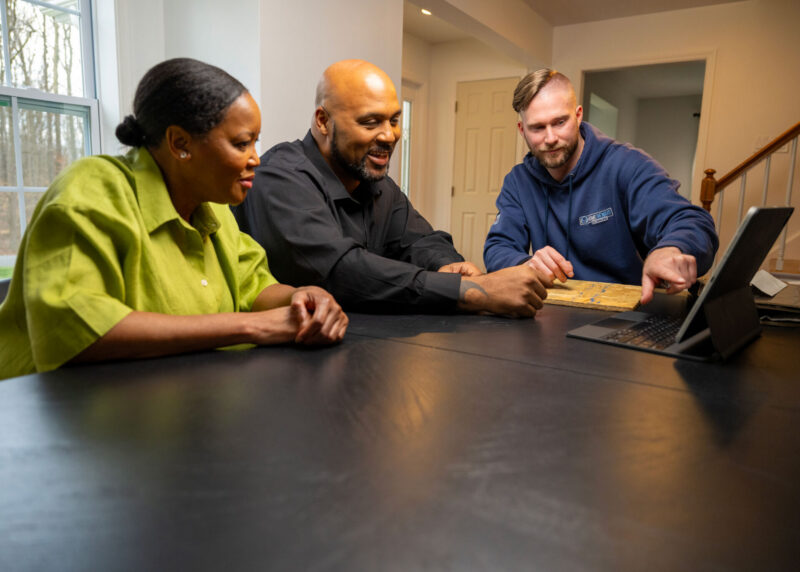 Home Remodeling Expert Discussing Window Replacement Project With Homeowners