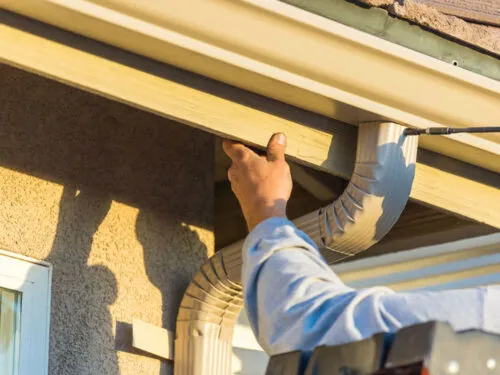 Home Contractor Installs Tan Gutter System