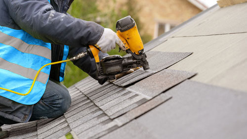 Roofing Contractor Installing Asphalt Shingle Roof