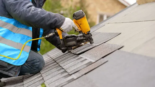 Roofing Contractor Installing Asphalt Shingle Roof
