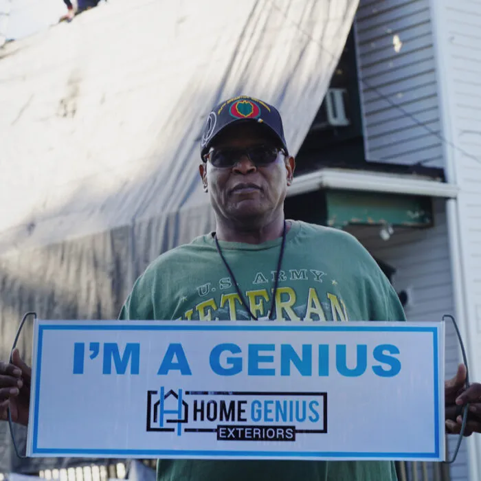 veteran posing with the HGE "I'm a Genius" sign
