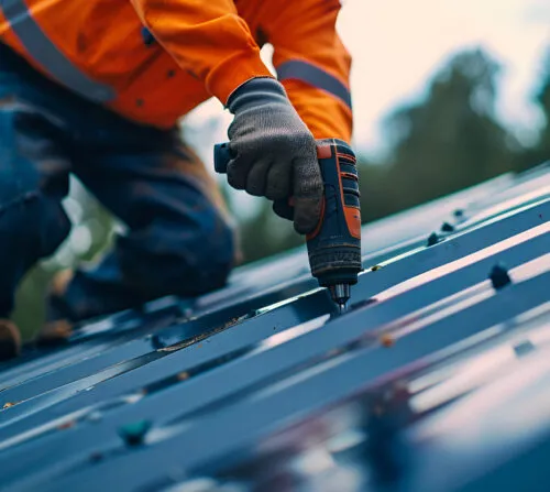 Nail gunning metal roof panels during installation