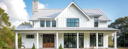 Stunning home with vertical white vinyl siding and custom metal roofing