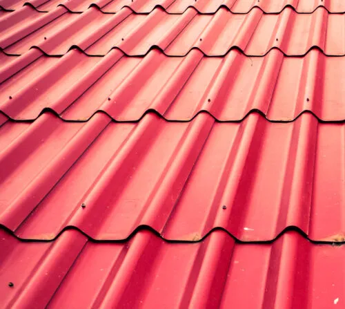 Red metal roofing panels installed