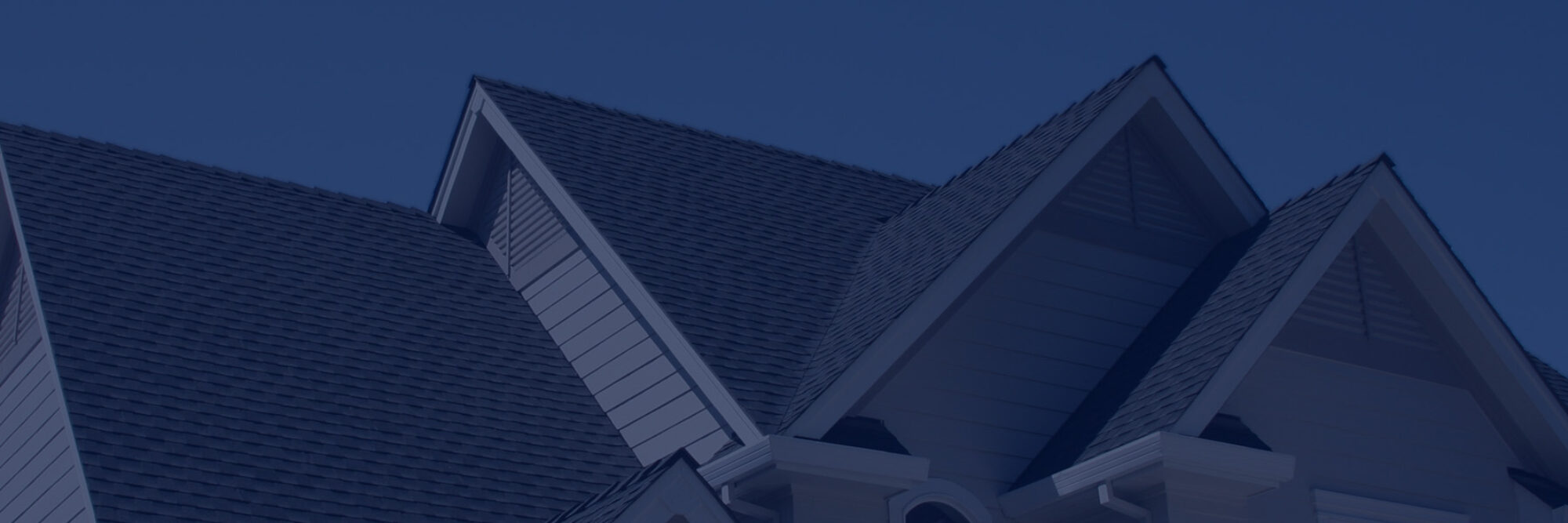 shot of residential roof against a clear blue sky