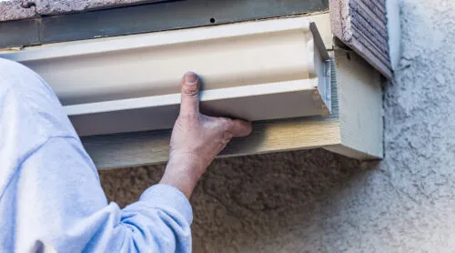 technician installing a gutter system