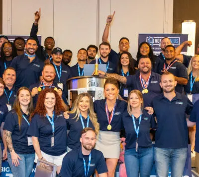 Group photo of HGE employees celebrating top performing members