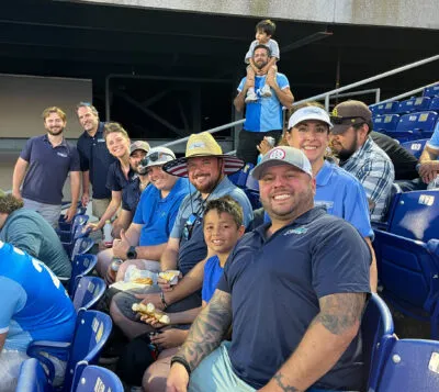 Group photo of HGE team members celebrating at a sport event