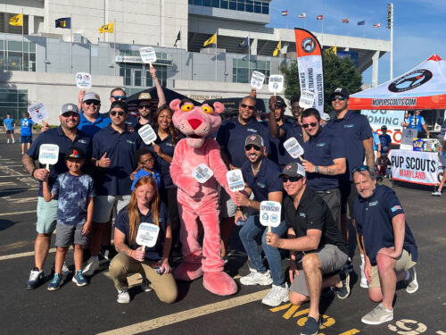 group photo of Home Genius exteriors team members with the Annapolis Blues FC stadium in the background