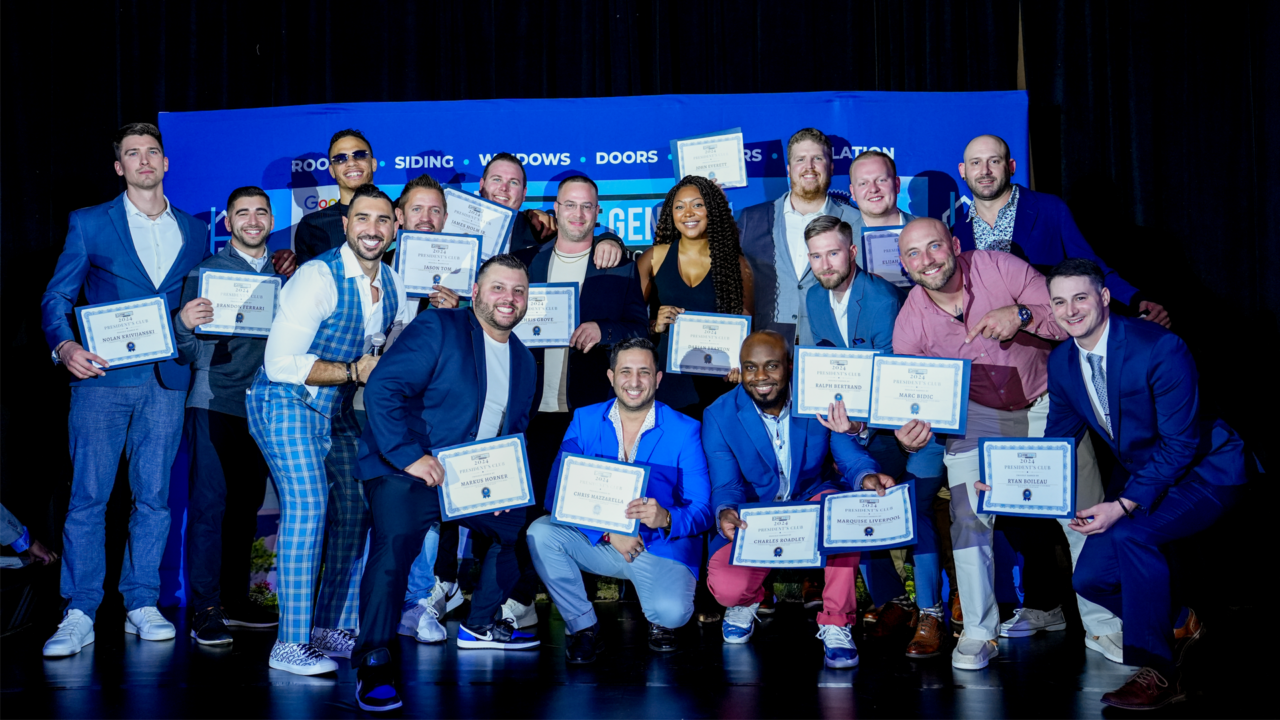 group photo of Home Genius Exteriors employees displaying awards
