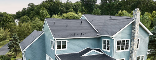 drone capture of a metal roof on a blue home