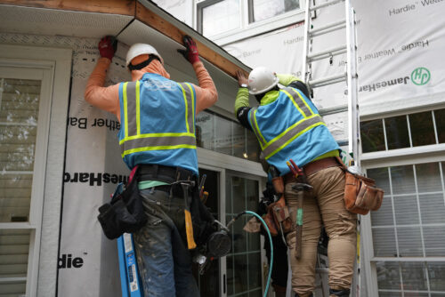 Home Genius Exteriors technicians installing new gutters