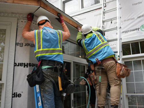 Home Genius Exteriors technicians installing new gutters