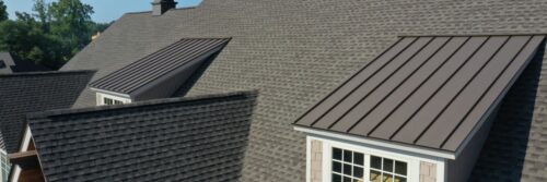 Asphalt roofing on home with metal dormers