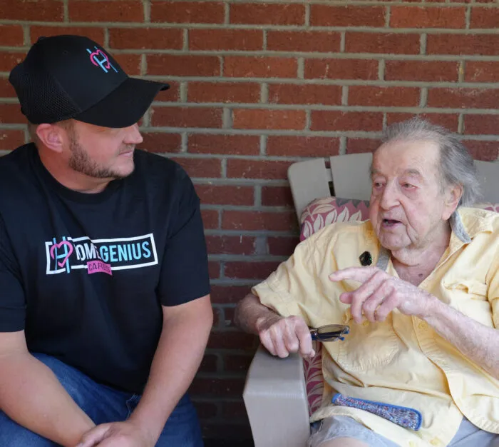 Co-Founder Brent Miller posing with veteran recipient of free roof