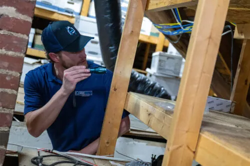 HGE home remodeling expert performing an attic inspection