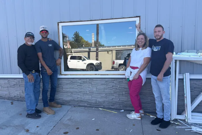 Home Genius team members smiling outside of Joey's Restaurant