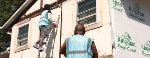 two HGE install techs looking at a house during a siding removal