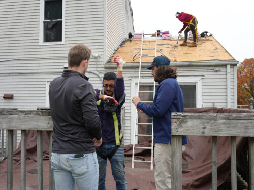 HGE team members setting up a camera during a roof deployment