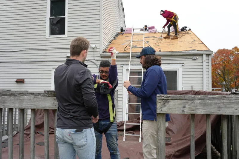 HGE team members setting up a camera during a roof deployment