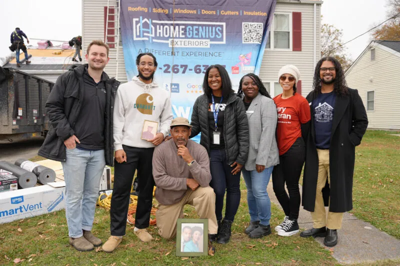 Eric Jones Sr. and his family posing with their HGE installation team in front of his home during a renovation
