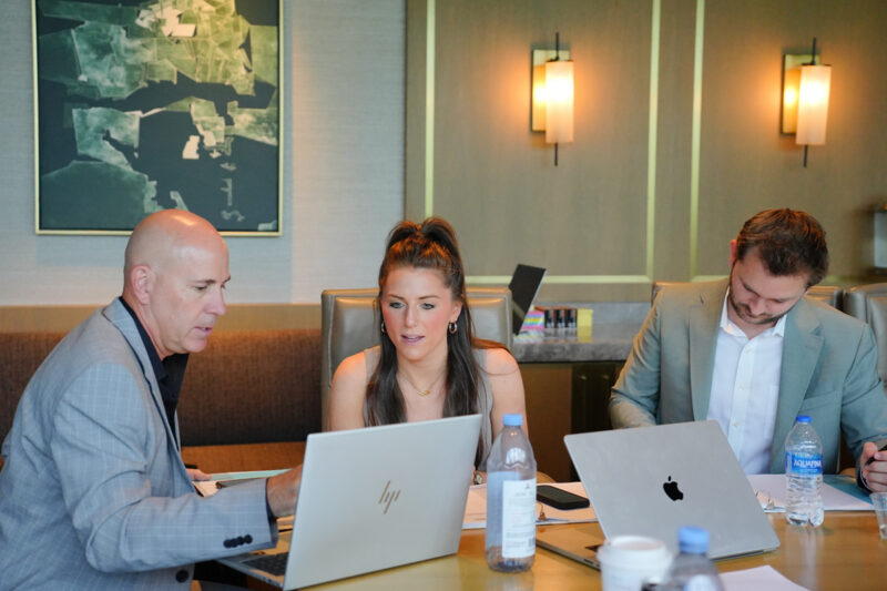 HGE's Jamie DePaul discussing business with senior leaders