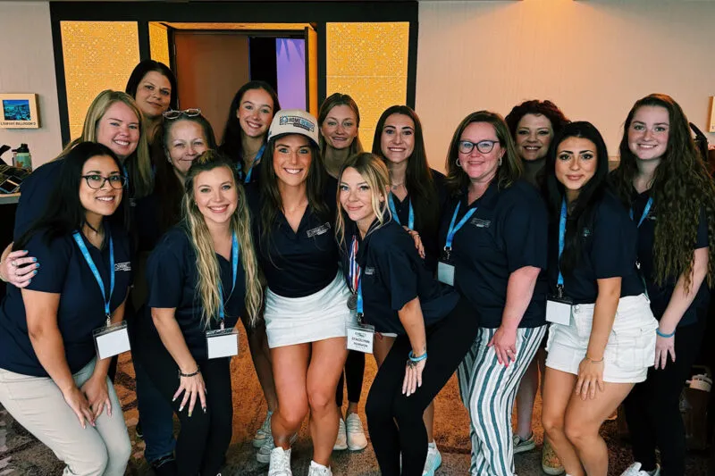 Jamie DePaul of HGE posing with a group of women in roofing