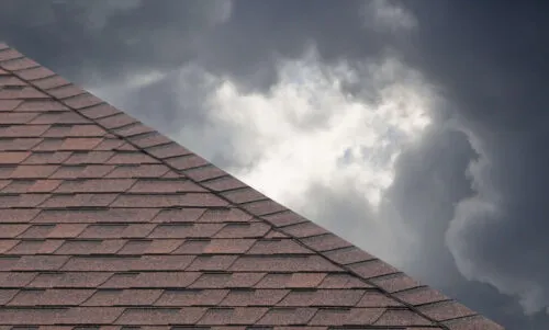 dark storm clouds behind a roof