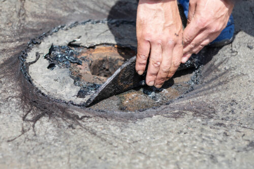 damaged flat roof draining system repair