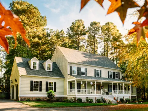 stunning home with wraparound porch in fall