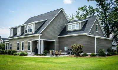 A two-story home exterior shows several windows of the kind local code checks for size and height.