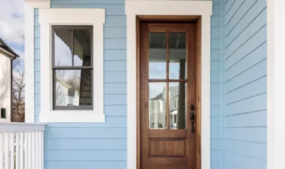 An entry door with a tall glass panel stands in a covered doorway, the subject of this comparison.