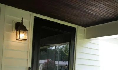 A full-glass storm door mounted in front of a covered entry, the second door this article explains.